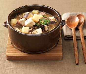 Doenjang Jjigae (Soybean Paste Stew)-This stew-like Korean dish is made by boiling an assortment of ingredients such as meat, clams, vegetables, mushrooms, chili, tofu, and soy paste.